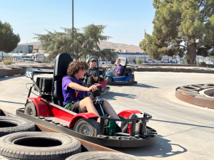 Boy driving a go kart around a track at Fiesta Fun Center