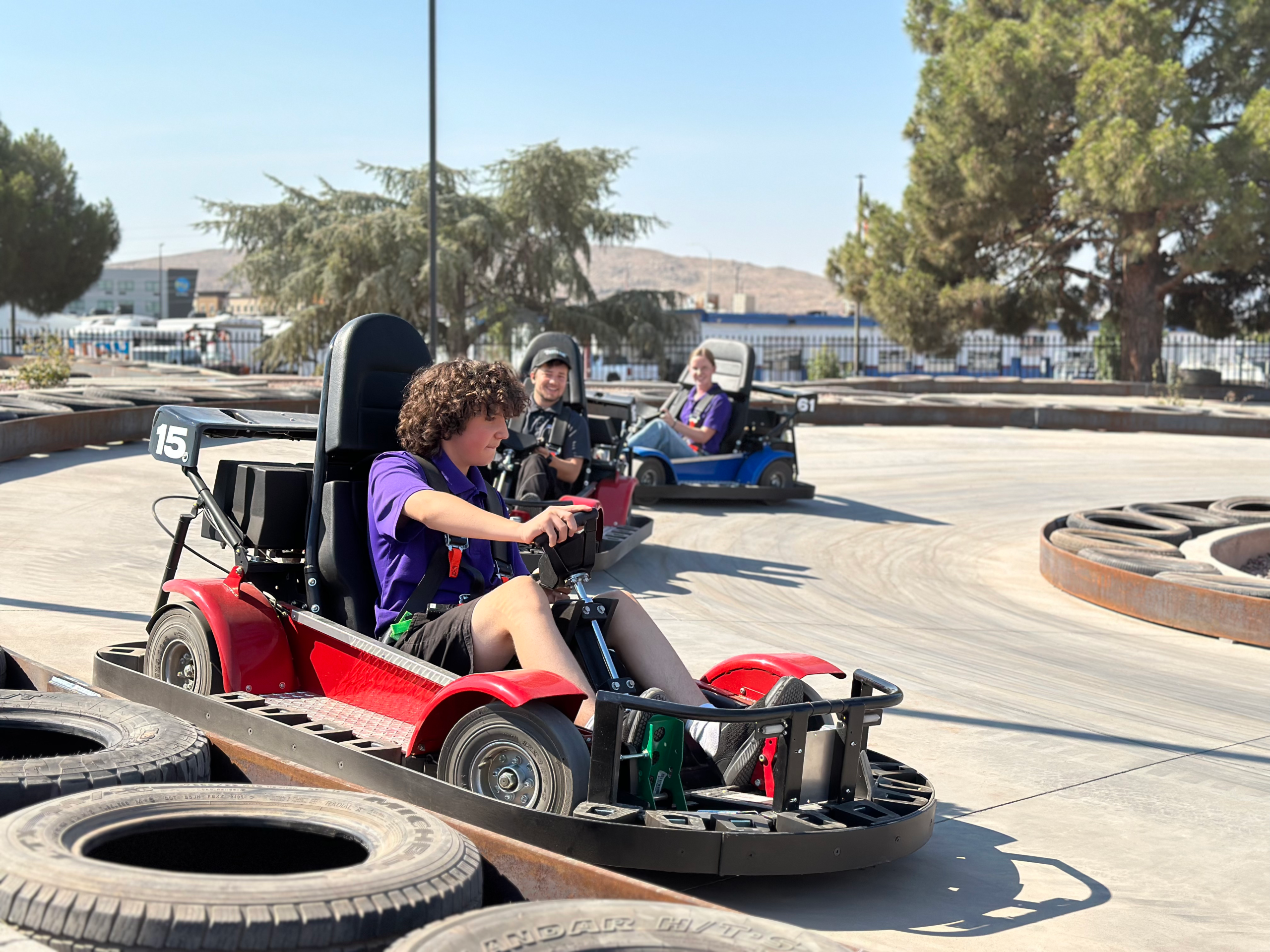 Boy driving a go kart around a track at Fiesta Fun Center