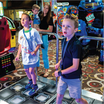 Birthdays. Kids playing dance dance in the arcade.