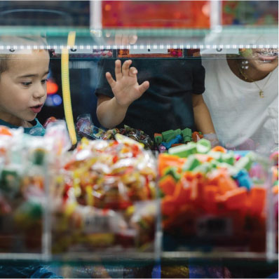Kids looking at claw machine prizes